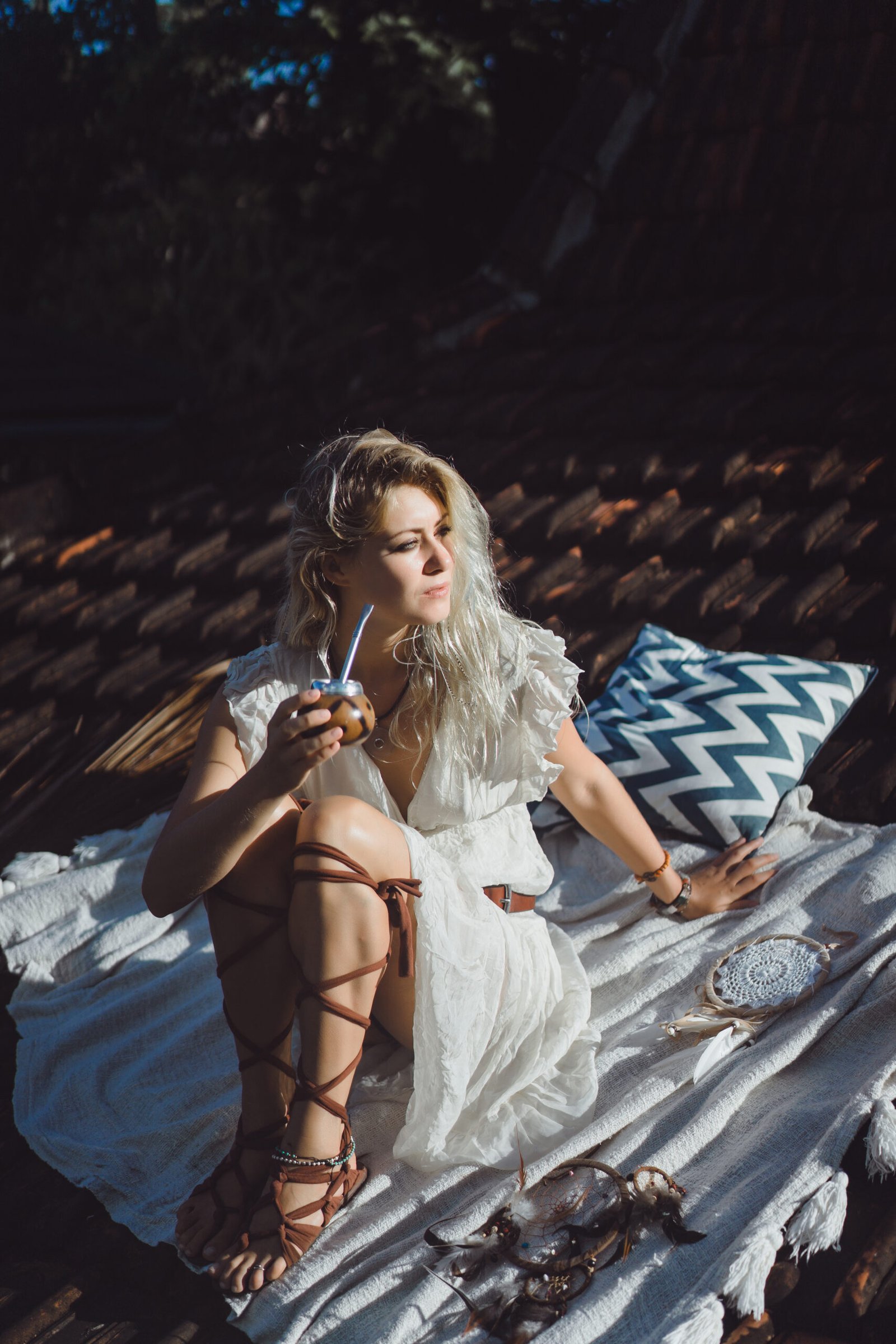 beautiful indian hippie girl with long blond hair roof drinking mate tea scaled