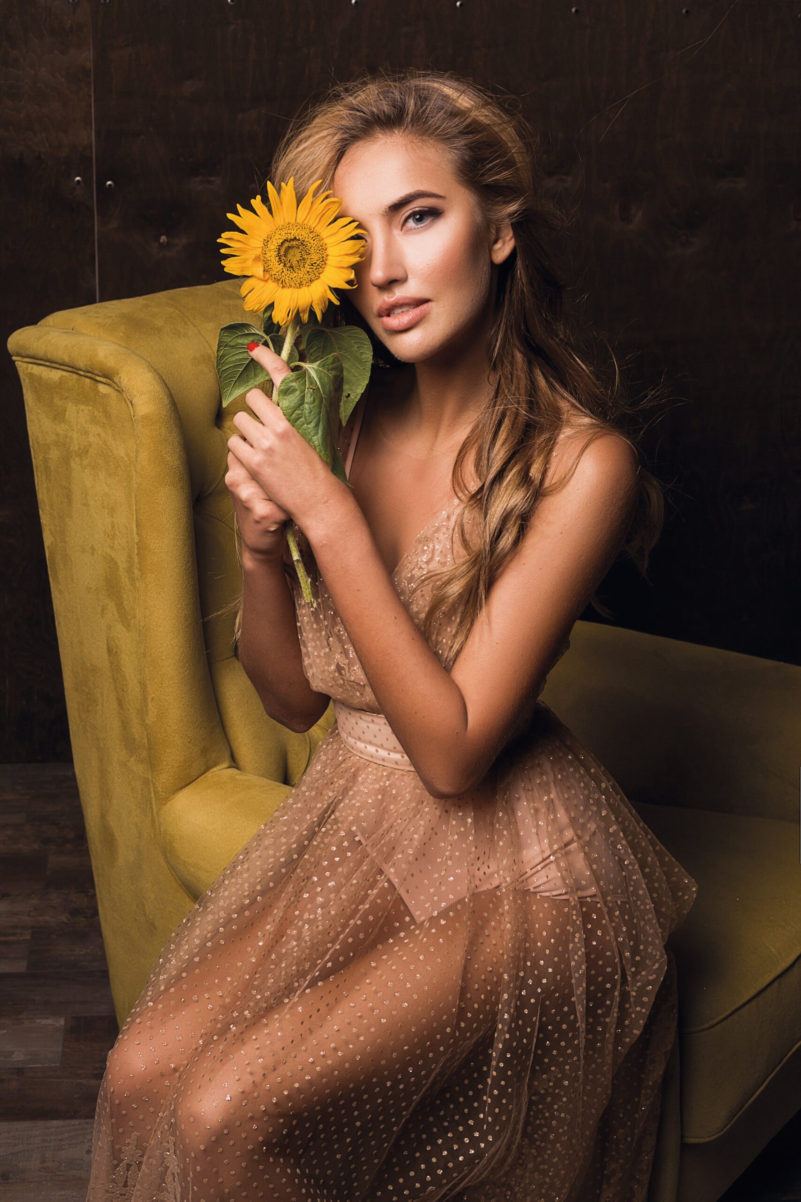 beautiful sensual woman sitting armchair posing with sunflower scaled