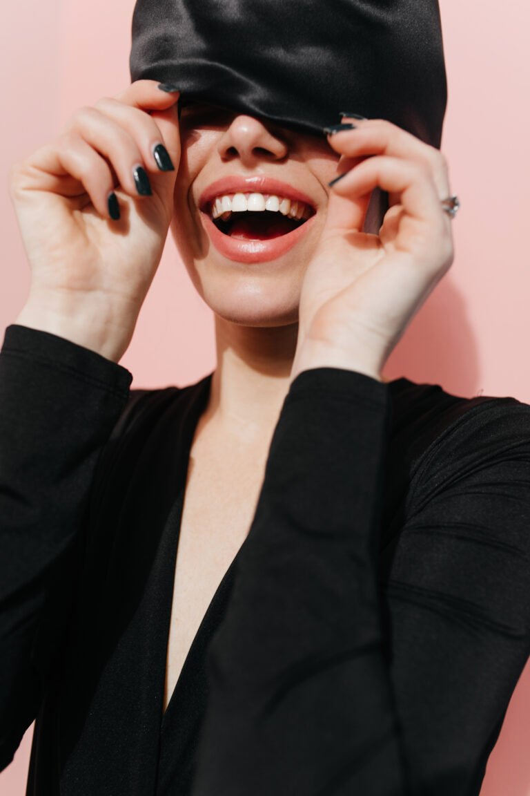 blisful girl posing with trendy black head scarf studio shot positive female model turban laughing pink background