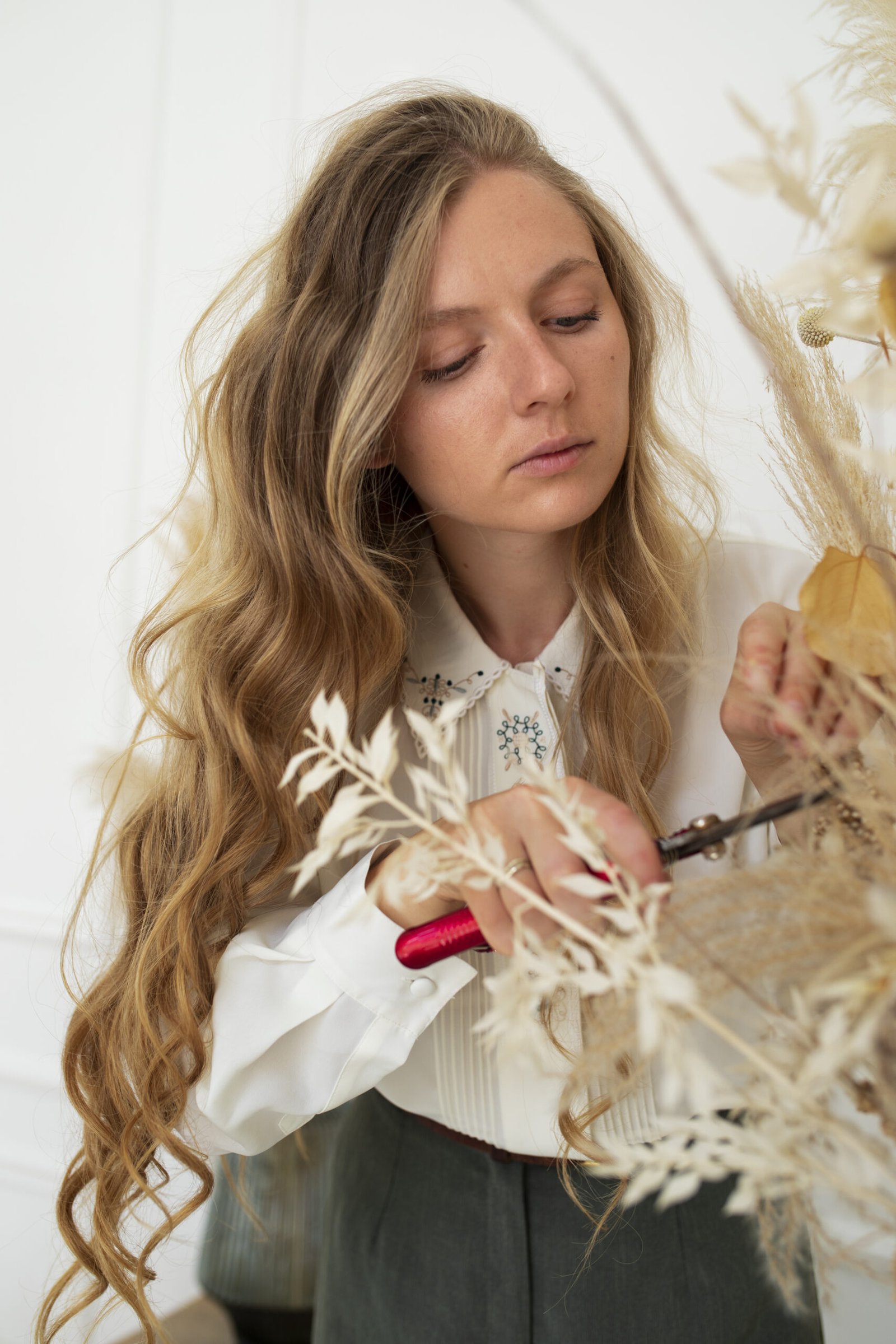 medium shot woman cutting dried flower 2 scaled