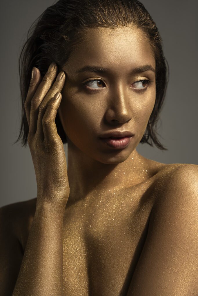 Acne Scarring Treatments Compared: What Actually Works 1 medium shot woman posing with gold body painting 2