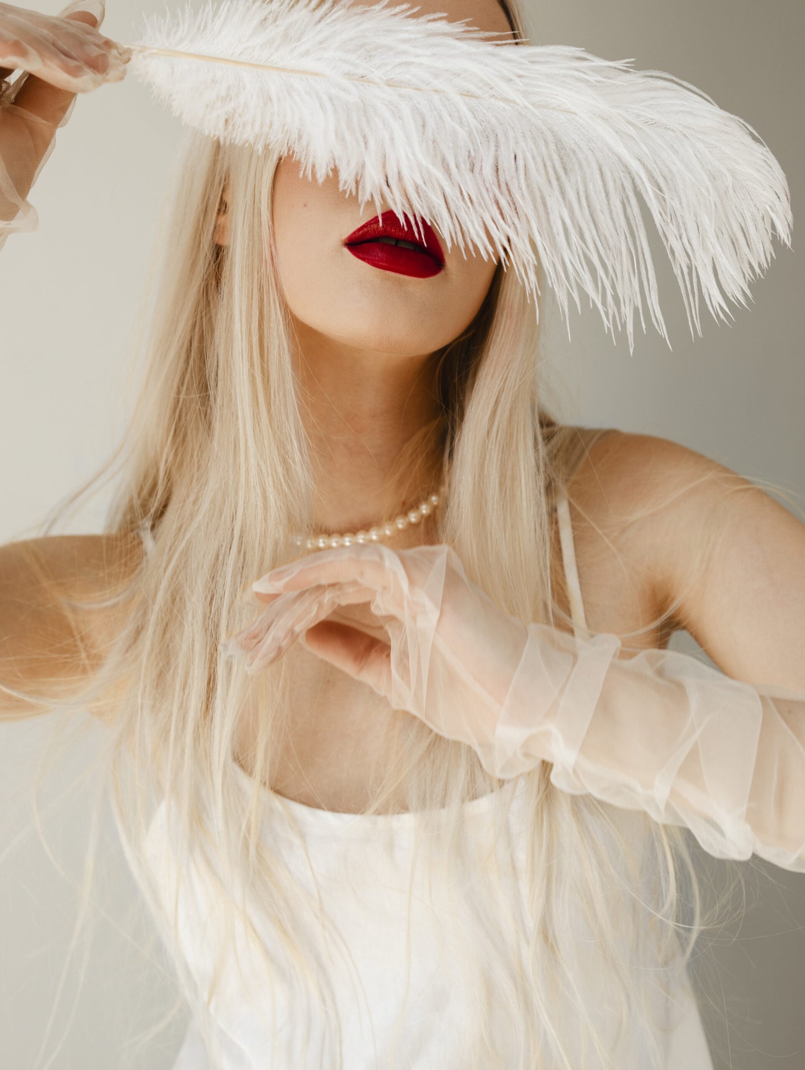 portrait beautiful albino woman with white feather scaled