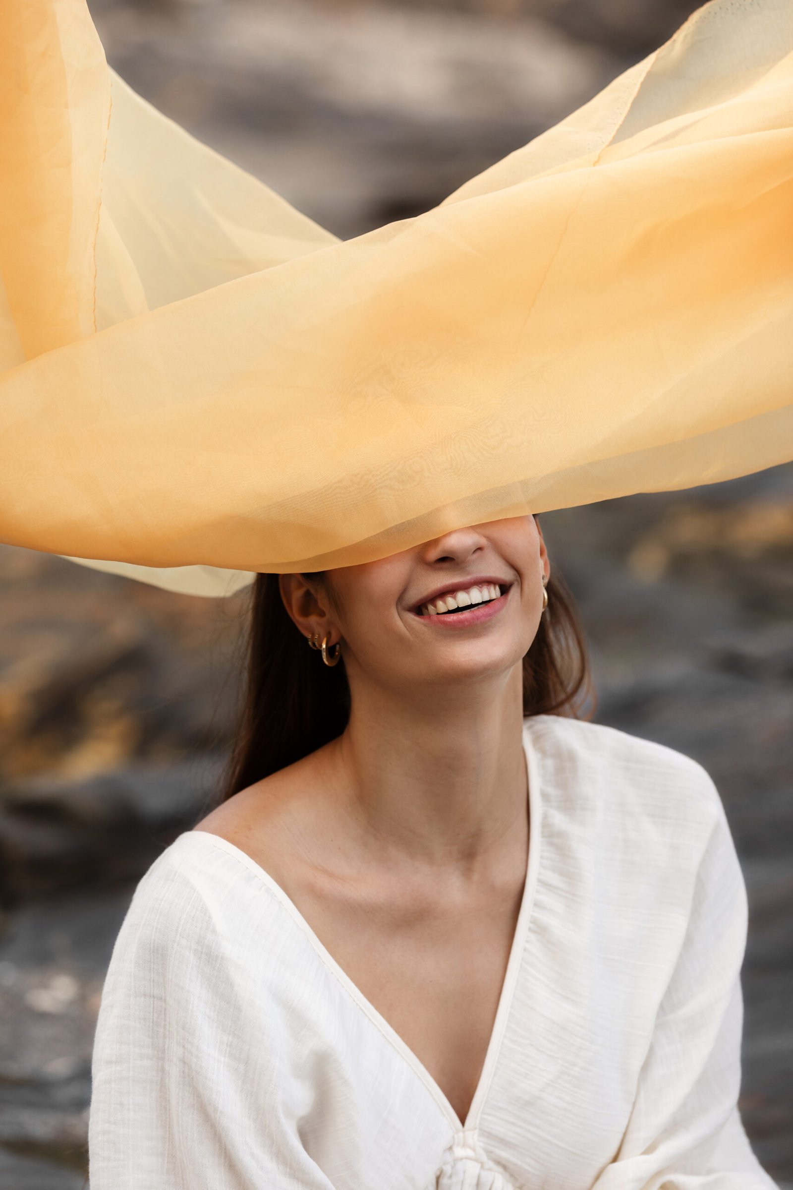 portrait woman beach hiding her face veil scaled