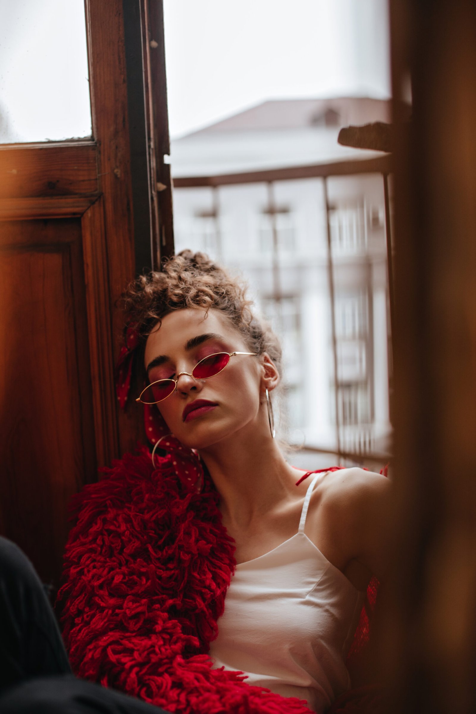 woman red stylish eyeglasses poses balcony scaled