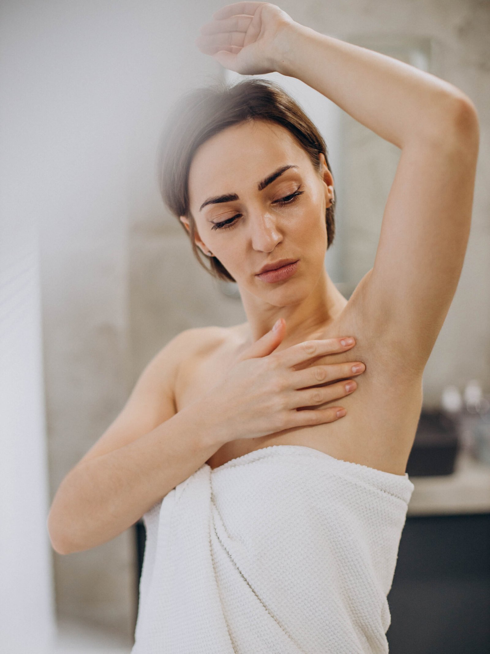 woman showing arritated skin arm after deodorant scaled e1789384670240