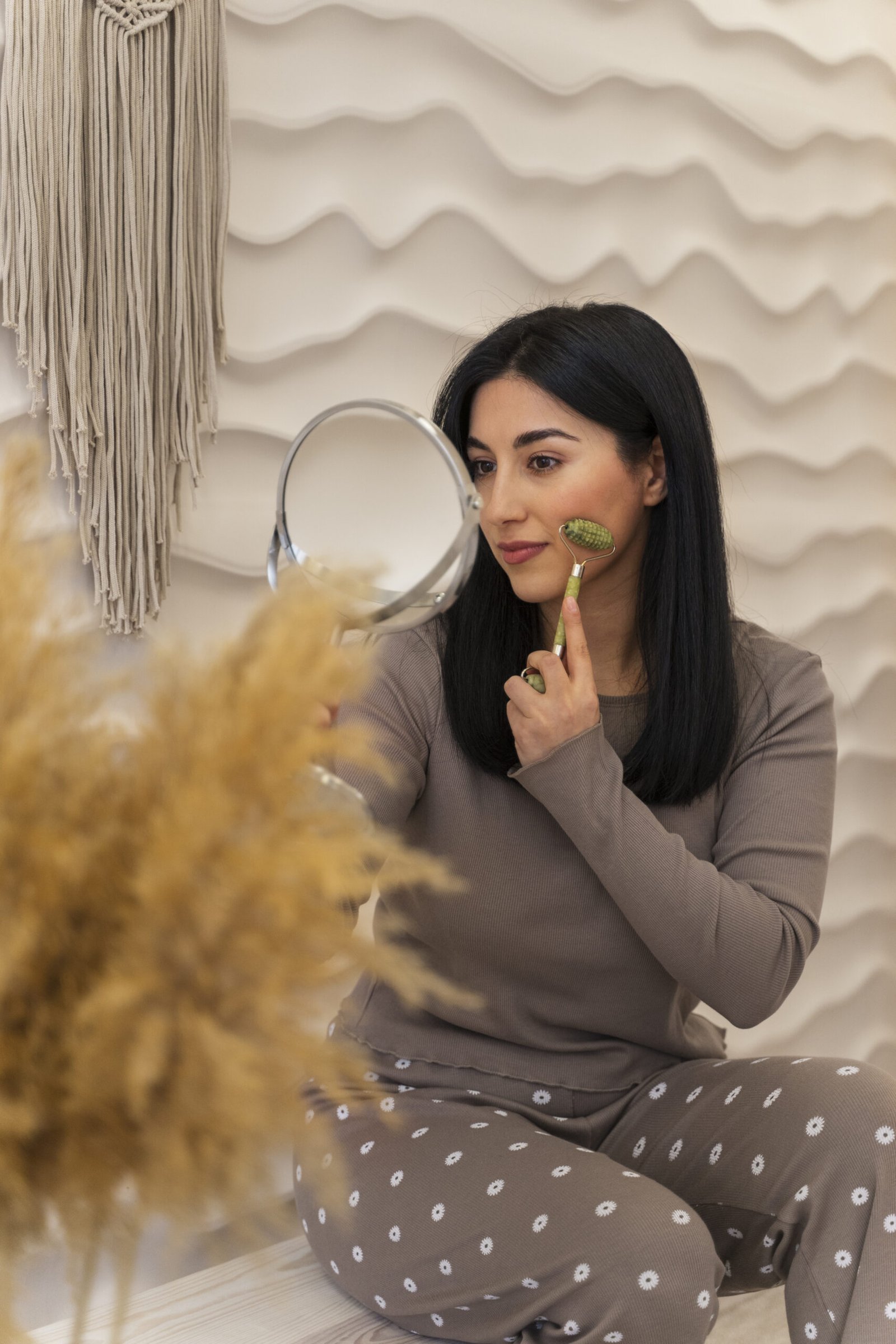 woman with jade roller doing her beauty routine scaled