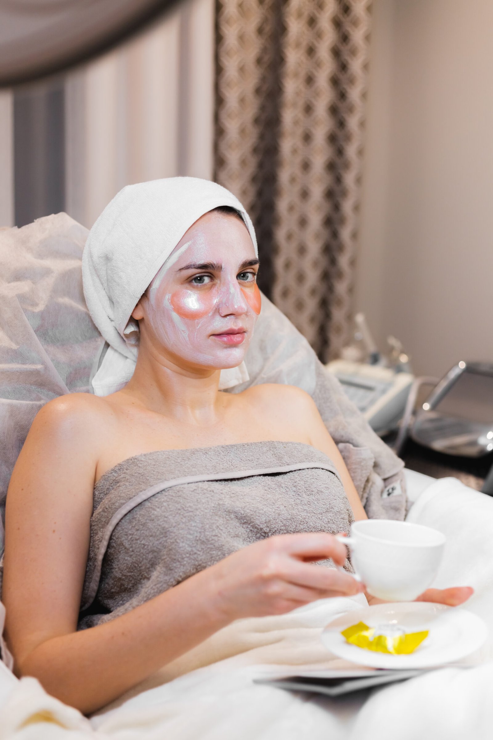 young girl beauty salon cosmetology room lies bed relaxes with mask her face patches her eyes scaled