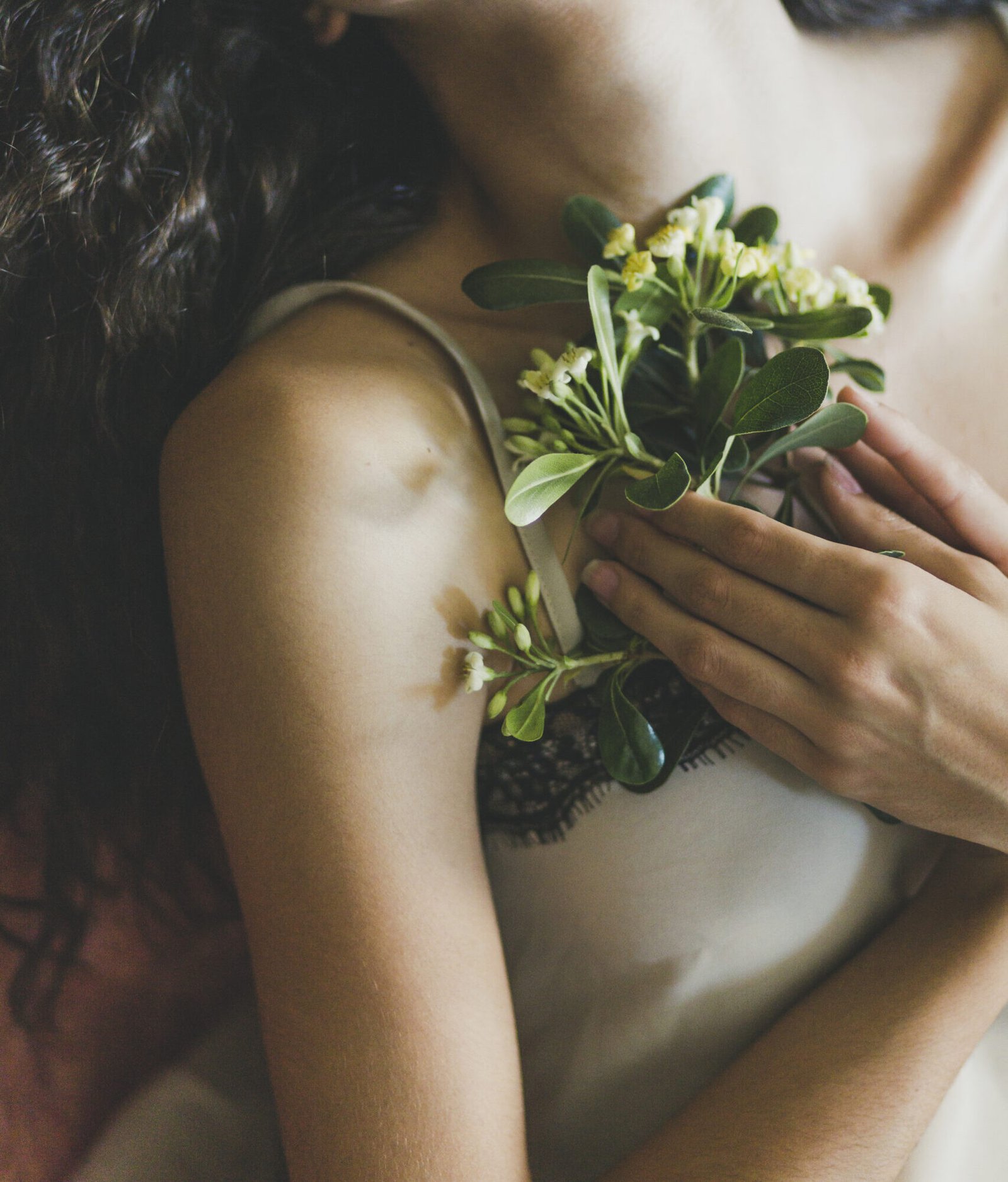 young woman keeping flowers near chest scaled e1788780639903